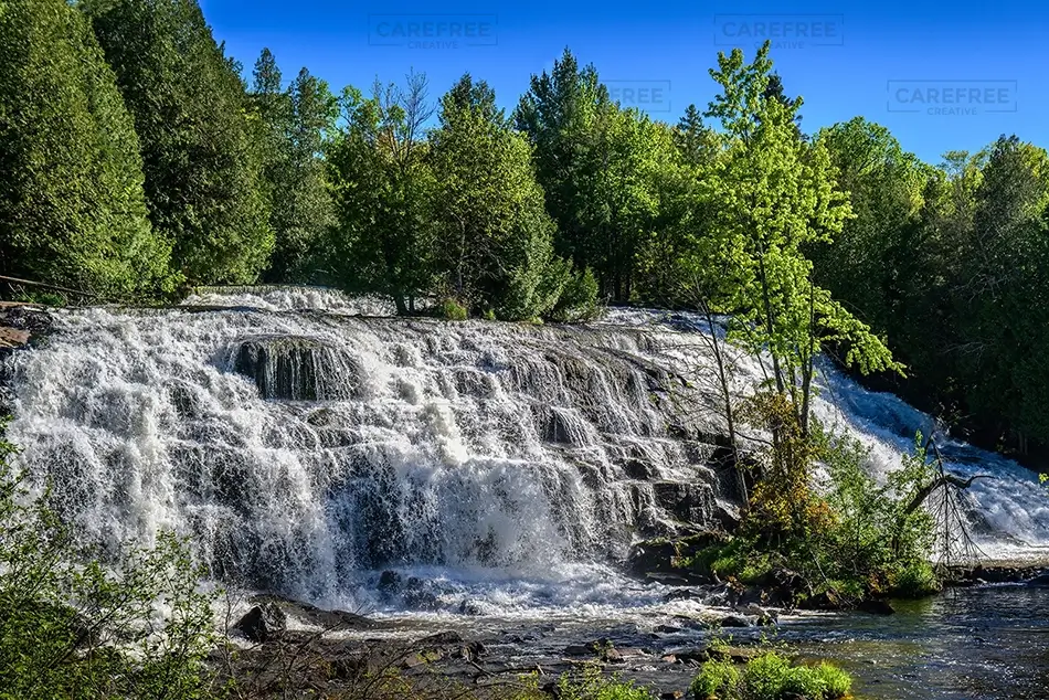 Bond Falls Sunlit Waterfall in the Forest, Trout Creek, Michigan · United States