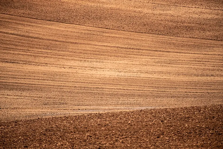 Canyon of the Ancient National Monuments Plowed Brown Soil Texture Field, Cortez, Colorado · United States