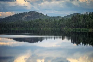 Kootenai Falls Suspension Bridge Forested Lake Reflection
