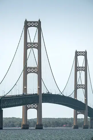 Mackinac Bridge Suspension Towers Over Water, Mackinaw City, Michigan