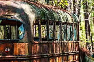 Old Car City USA Rusty Bus in Woods, White, Georgia