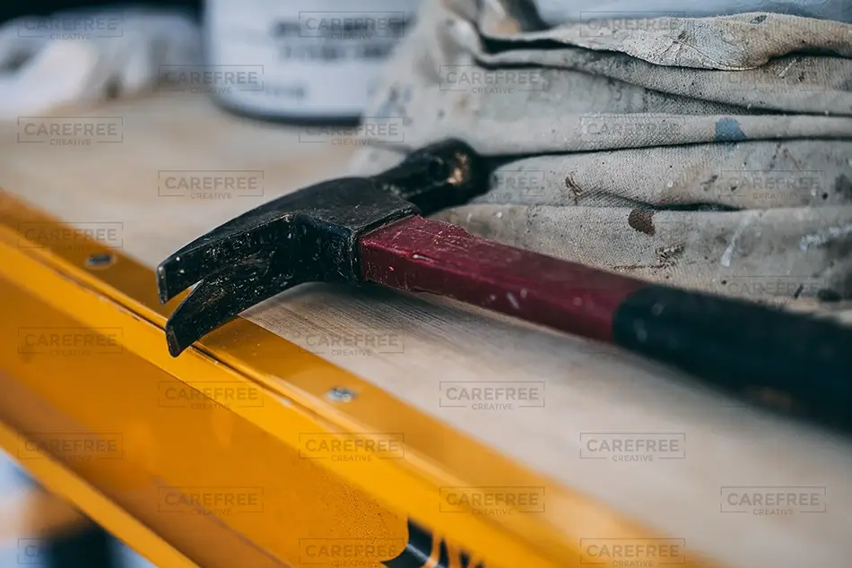 Painting Claw Hammer On Ladder