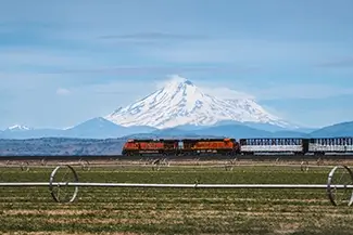 California Freight Train Passing Snowy Mountain