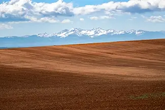 Canyons Of The Ancients Snowy Peaks Over Brown Earth