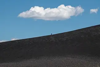 Craters Of The Moon Hiker On Volcanic Slope